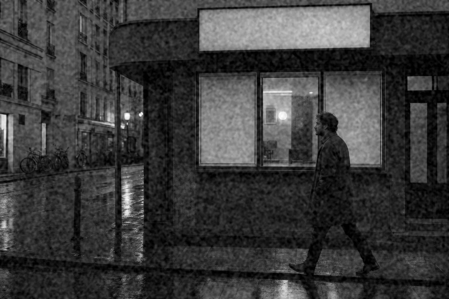 Black-and-white rainy street with visible, rough grain and deep contrast in the style of Tri-X 400