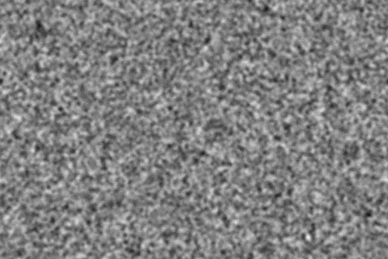 Neutral-gray Super 8-scale film grain texture with large, rough clusters
